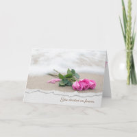 pink roses on beach sand with torn edge border