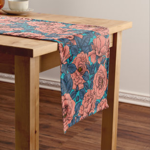 Pink roses with blue leaves on blue short table runner