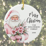 Pink Santa Merry Christmas Ceramic Ornament<br><div class="desc">Add a festive and feminine touch to your holiday season with this Christmas ornament featuring a stylish watercolor Santa Claus on the left side. Santa is dressed in a soft pink coat and matching hat, holding a bouquet of pink poinsettias, holly berries, and pine sprigs—bringing a whimsical and fashion-forward flair...</div>