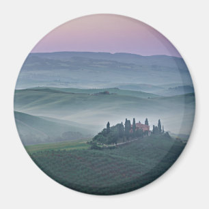 Pink sunrise over a Tuscany landscape round magnet