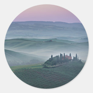 Pink sunrise over Tuscany landscape round sticker