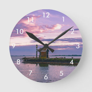 Pink sunset over lake round clock