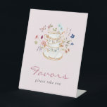 Pink Tea Party Favours Pedestal Sign<br><div class="desc">Enhance your favour table with our Blush Pink Wildflower Bridal Tea Party Favour Sign. Featuring stunning hand-painted watercolor florals in deep purple, dusty blue, and blush pink with sage greenery, this sign beautifully adorns cream and gold floral teacups and saucers, all set against a delicate blush pink background with a...</div>