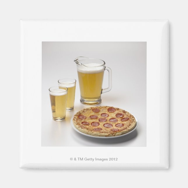 Pitcher and two pints of beer beside pepperoni magnet (Front)