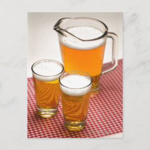 Pitcher of beer and two glasses filled with beer postcard