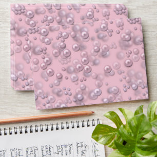 Placers of white-pink pearls on pink velvet envelope