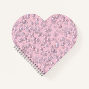 Placers of white-pink pearls on pink velvet notebook