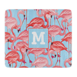 Planche À Découper Les Flamants roses roses lumineux sur le bleu |