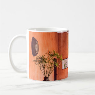 PLANTERS WITH PLANT NEAR AREA RUG INSIDE ROOM COFFEE MUG