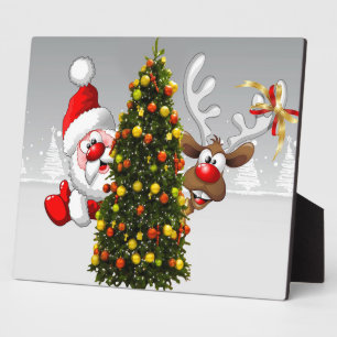 Plaque Photo Santa claus and reindeer behind a christmas tree.j