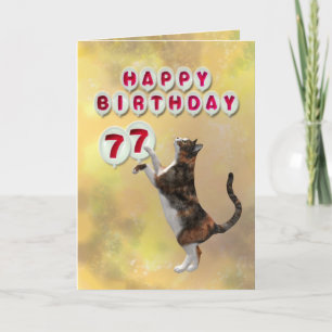 Playful cat and 77th Happy Birthday balloons Card