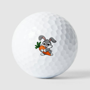 Playful rabbit with a big carrot golf balls