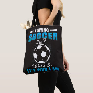 Playing soccer tote bag