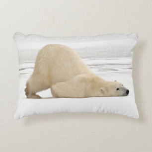 Polar bear scratching itself on frozen tundra decorative pillow