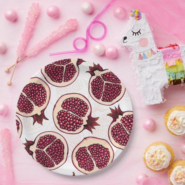 Pomegranate slices on white paper plate (Party)