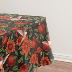Pomegranates and hummingbirds/green leaves on blac tablecloth