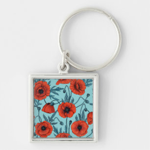 Poppies, red and blue on pool blue keychain