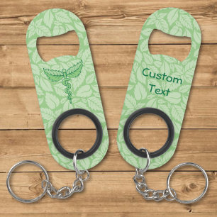 Porte-clé Décapsuleur Caducée avec fond de feuilles