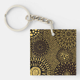 Porte-clés en acrylique noir et or à motif floral 