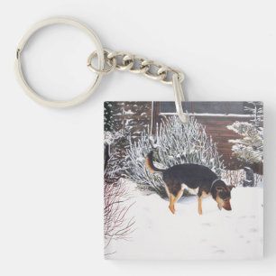 Porte-clés Enneigement hivernal avec un mignon chien noir et