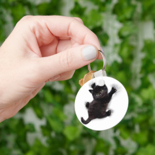 Porte-clés Escalade de chat noir sur le dos humain