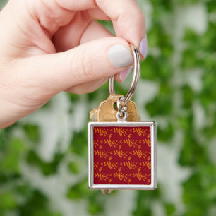 Porte-clés Feuilles de branches de silhouette orange sur roug