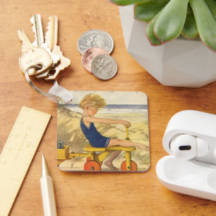 Porte-clés Garçon vintage jouant à la plage avec des jouets d