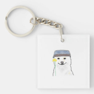 Porte-clés Joli chien blanc portant un chapeau tenant une fle