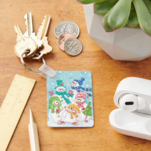 Porte-clés Jolie famille des neigeurs de Noël dans la neige