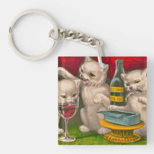 Porte-clés Les chatons boivent et mangent du poisson sardine