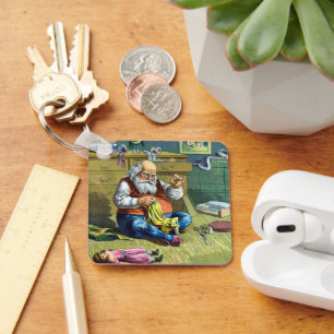 Porte-clés Noël vintage, le Père Noël fabriquant des poupées