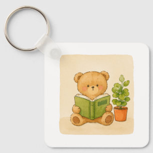 Porte-clés ourson en peluche lisant un livre
