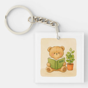 Porte-clés ourson en peluche lisant un livre