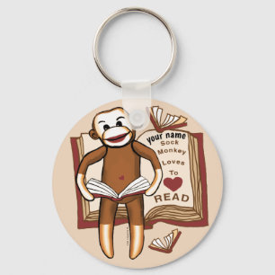 Porte-clés singe en chaussette lisant