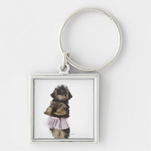Porte-clés Un chiot de Yorkie-poo dans un tutu sur ses jambes