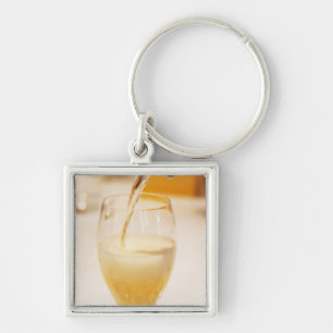 Porte-clés Une flûte à champagne remplie de Gosset