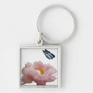 Porte-clés une grande pivoine rose est visitée par un éthé