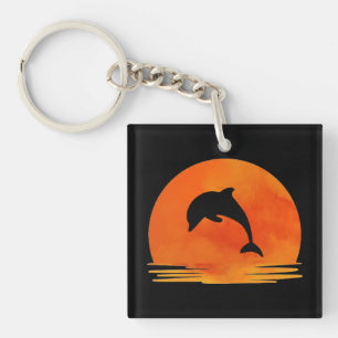Porte-clés Une silhouette de dauphin sautant au coucher du so