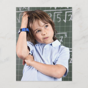 portrait of young boy in classroom in front pof postcard