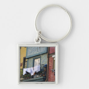 Portugal, Oporto (Porto). Woman hanging laundry Keychain