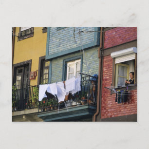 Portugal, Oporto (Porto). Woman hanging laundry Postcard