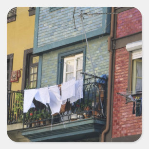 Portugal, Oporto (Porto). Woman hanging laundry Square Sticker