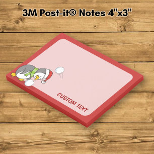 Post-it® manchot de Noël ramassant une boule de neige