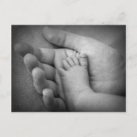 Postcard of baby's foot in mothers hand.