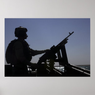 Poster Un technicien maniant une mitrailleuse M240 en Ira