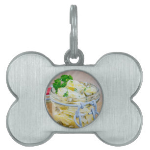Potato salad in a jar on wooden pet ID tag