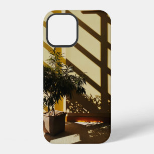 Potted green plant on brown wooden table iPhone 12 case
