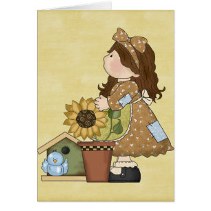 Poupée adorable de pays avec le tournesol