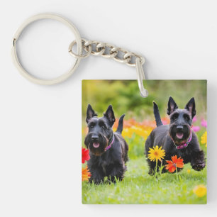 Prancing Scottish Terriers in grass and flowers Keychain