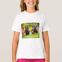 Prancing Scottish Terriers in grass and flowers